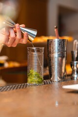 Vertical shot of a bartender preparing a mojito