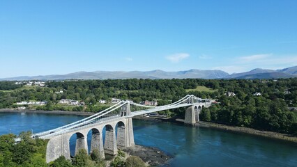 Aerial view of the Suspension bridge over the Menai with a blue sky in the background, UK