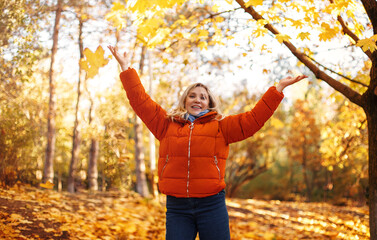 Cheerful woman in autumn park