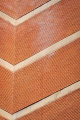 Vertical shot of an orange brick wall of a solid construction