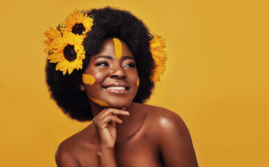 Black person, studio and sunflower for skincare with glow, natural cosmetics and soft skin. Floral,...