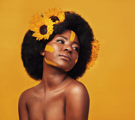 Black woman, beauty and sunflower with skincare in studio for natural glow, dermatology or soft...