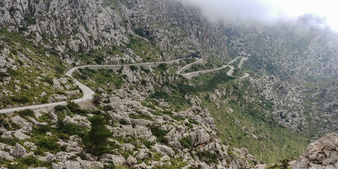 Winding road on a mountain in Mallorca on a foggy day