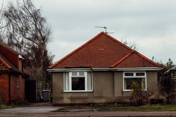 Gloomy day with an overcast sky over an old one-story home