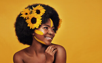 Black person, plant and sunflower with skincare in studio for organic glow, cosmetics or soft skin....