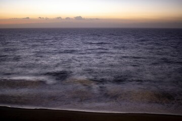 Fototapeta premium Beautiful shot of a bright sunset sky over the blue sea