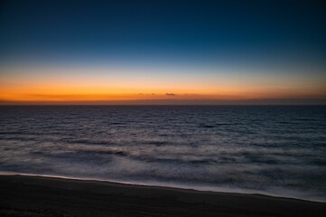 Fototapeta na wymiar Beautiful shot of a bright sunset sky over the blue sea