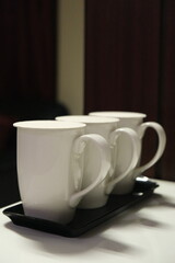 Vertical closeup shot of white mugs
