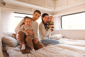 Portrait of the smiling happy family with kids in the house on wheels