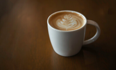 Hot latte art coffee cup on wooden table