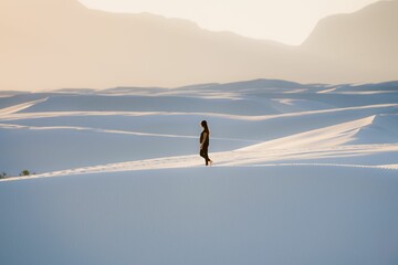 Female in black clothing looking forward at White Sands National Park, New Mexico