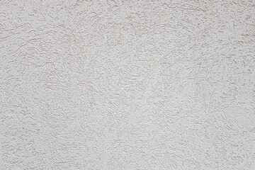 abstract background of white embossed plastered wall painted white close up