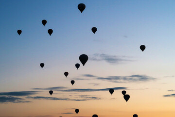 Many hot air balloons rising over the landscape of the Red Valley, Rose Valley, close to Goreme,...