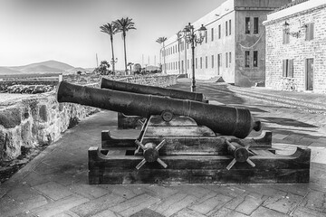Disused cannons on the historic ramparts in Alghero, Sardinia, Italy - 783672652