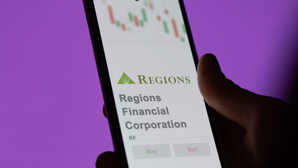 April 09th 2024 , Birmingham, Alabama. Close up on logo of Regions Financial Corporation on the screen of an exchange. Regions Financial Corporation price stocks, $RF on a device.