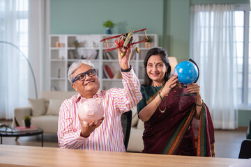 Retired Indian senior couple having fun while vacation planning, world tour or holiday travel.