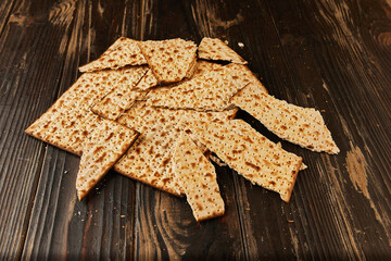 Passover celebration concept - Jewish holiday Passover. Whole Matzo and matzo broken into pieces on a wooden background with a beautiful composition