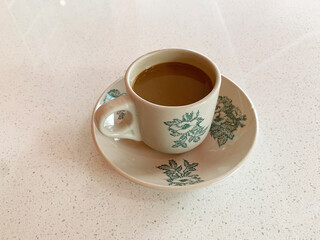 hot drink milk tea leaf bag, milo , kopi coffee mocha with milk in traditional cup and tea spoon and small plate on wood table color vegan healthy restaurant beverage cafe halal food menu