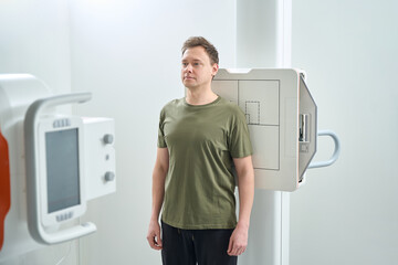 Adult man getting digital radiography of shoulder in anteroposterior projection