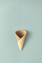 Cornet on pastel background. Minimal summer concept. Ice cream cone flat lay.