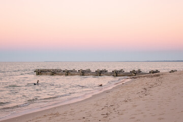 Dusk at Burrum Heads beach Queensland, old timber pier into water, pink and purple tones