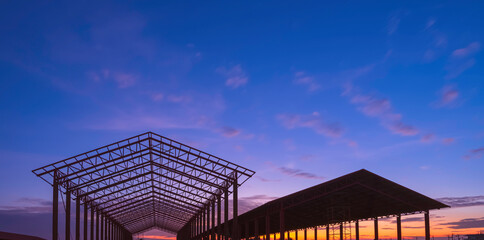 Silhouette two metal industrial buildings structure with gable roof beam outline framework in...