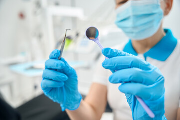 Fototapeta premium Dental hygienist checking sterility and cleansity of dental tools