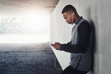 African man, phone and earphones with text, start and workout for training and health. Athlete,...