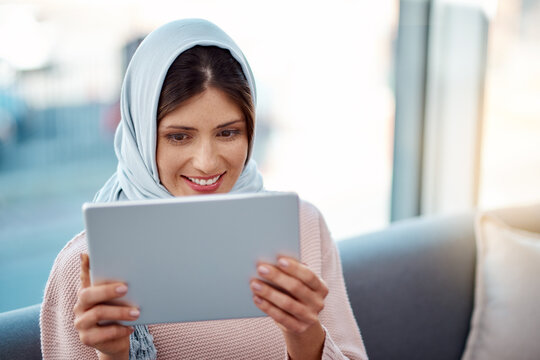 Smile, tablet and muslim woman on sofa in living room streaming movie, film or show for entertainment at home. Rest, digital technology and islamic female person watching video online at apartment.