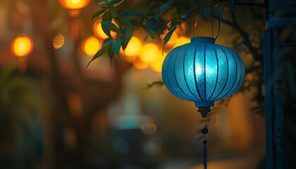A blue lantern hangs from a tree in a city street