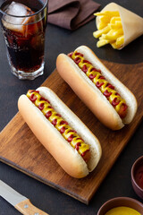 Hot dogs with grilled sausages, ketchup and mustard. Fast food.