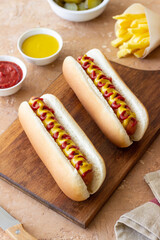 Hot dogs with grilled sausages, ketchup and mustard. Fast food.