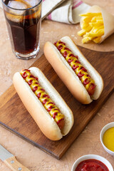 Hot dogs with grilled sausages, ketchup and mustard. Fast food.