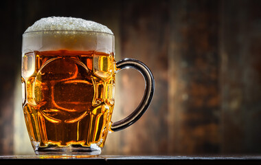 A pint of beer on wooden background