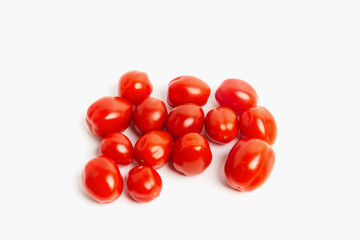Small sweet cherry tomatoes on a white background. Isolated