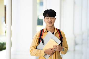 Smiling College Student Holding Books in School Corridor