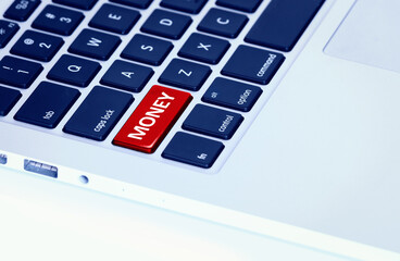 Closeup of a laptop keyboard with a red money button - 783711023