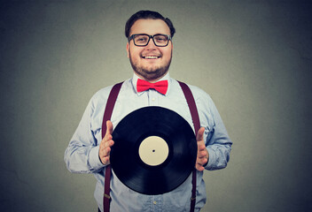 Happy smiling young man with a vinyl record  - 783711045