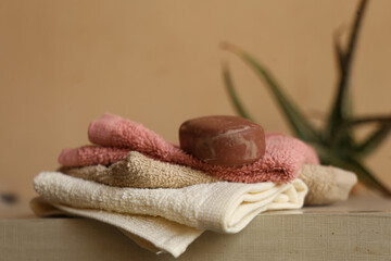 towel and soap on wooden table