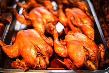 Whole chickens boiled in fish sauce for sale in the market are another very delicious Thai food.