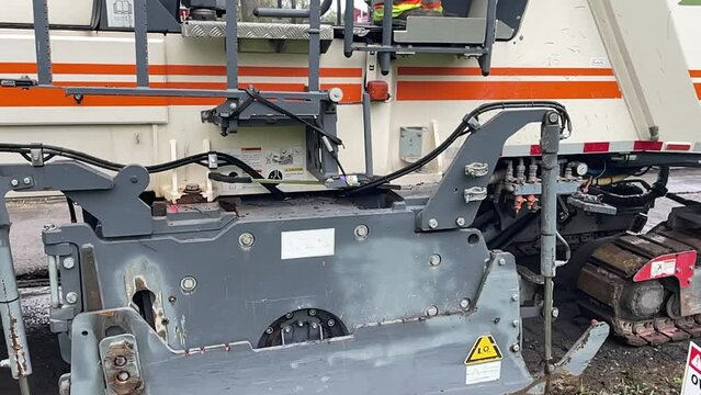 Close Up of a Cold Milling Machine Rolling over Concrete