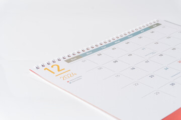 December calendar of 2024 displaying on white background. Desk calendar side view and selective focus shot for concept. 