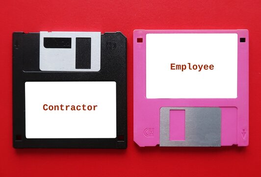 Two vintage floppy disk with text written CONTRACTOR and EMPLOYEE - workforce management trend of hiring Contractor (independent contractor worker) rather than full-time employee to save cost