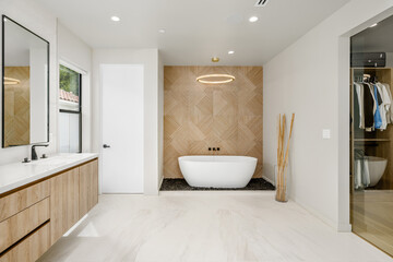 Fototapeta na wymiar an empty bathtub sits in the middle of a bathroom with wood cabinetry