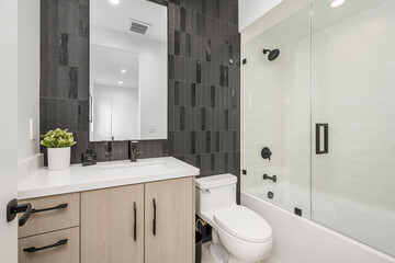 a small black and white bathroom is clean and ready for you to use