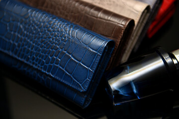 A multi-color ladies' purse made with premium quality leather of crocodile skin texture, placed on...