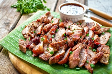 Grilled beef on banana leaf with thai spicy sauce,	