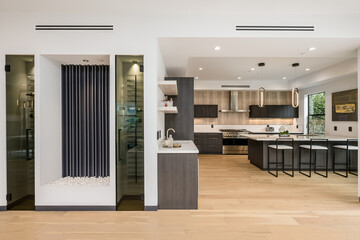 Concept kitchen with white walls and wooden floors, connected to dining area. - obrazy, fototapety, plakaty