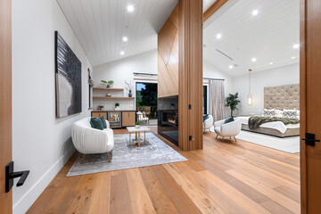 a living room with a wooden paneled wall and wooden floors