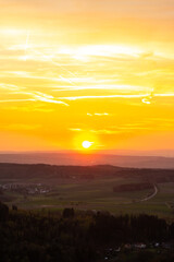 Panorama of a Romanesque landscape at sunset in the evening light. beautiful spring landscape in the mountains. Grass field and rolling hills. View from a rock to the horizon